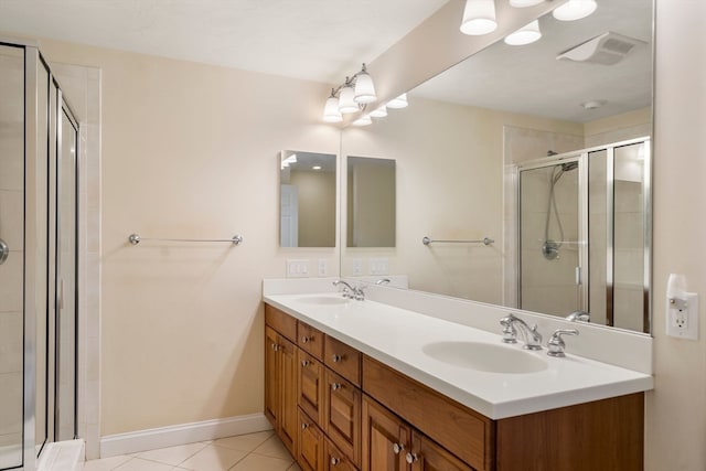 bathroom with tile patterned flooring, vanity, and an enclosed shower