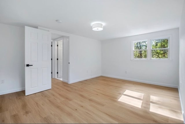 spare room featuring light hardwood / wood-style flooring