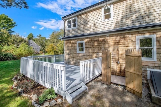 rear view of property featuring a wooden deck