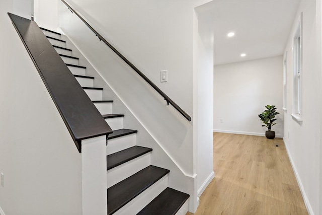 stairway featuring wood-type flooring