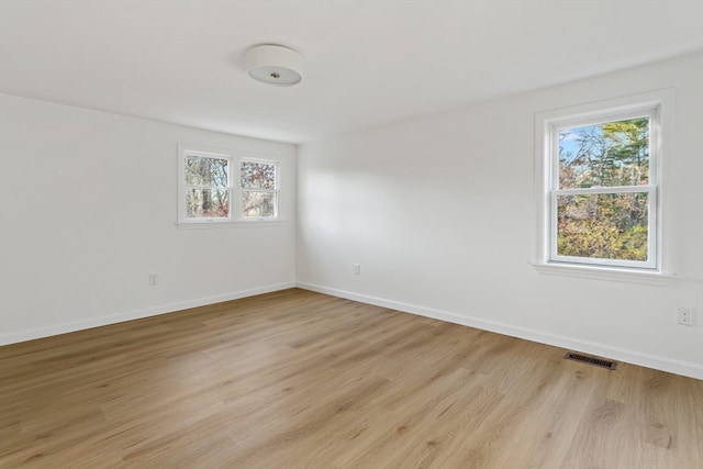 unfurnished room with light wood-type flooring