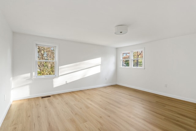 unfurnished room featuring light hardwood / wood-style floors