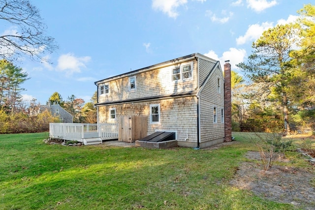 rear view of property with a lawn and a wooden deck