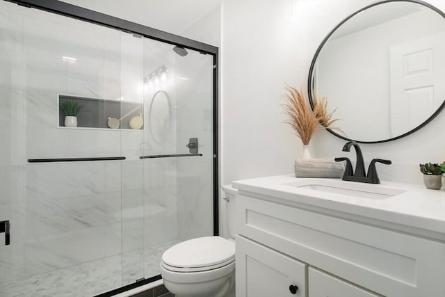 bathroom with walk in shower, vanity, and toilet