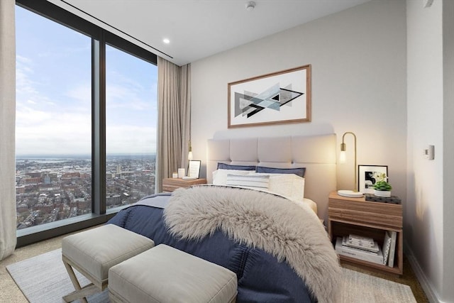 carpeted bedroom featuring multiple windows and expansive windows