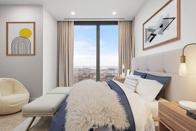 bedroom with floor to ceiling windows and multiple windows