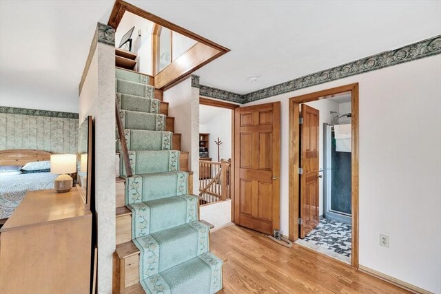 41 Kenwood Rd, Bourne, MA 02559 - stairway with baseboards, wood finished floors, and wallpapered walls