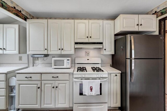 41 Kenwood Rd, Bourne, MA 02559 - kitchen with white cabinetry, white appliances, light countertops, and under cabinet range hood