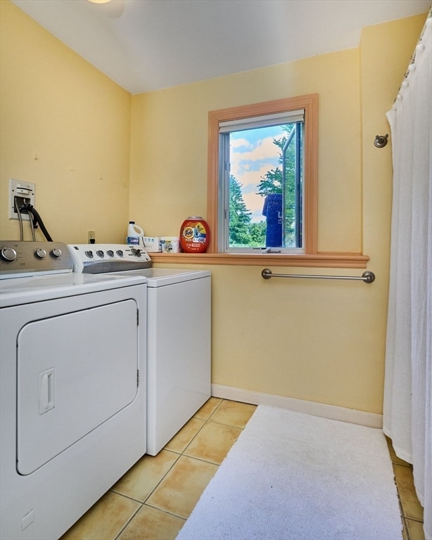 laundry area with light tile patterned flooring and independent washer and dryer