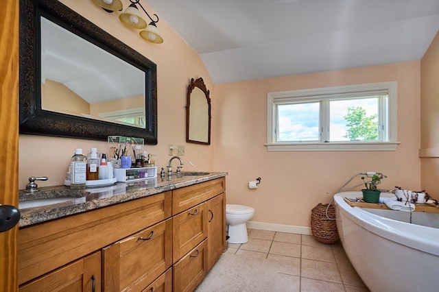 bathroom with vanity, a bathtub, toilet, tile patterned floors, and vaulted ceiling