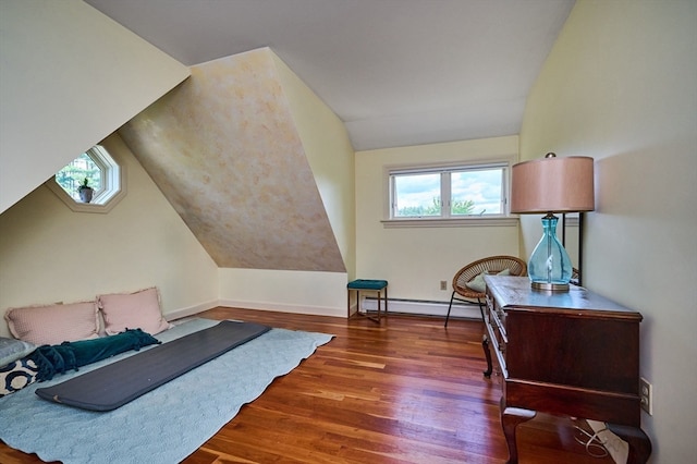 bedroom featuring vaulted ceiling, baseboard heating, and dark hardwood / wood-style flooring