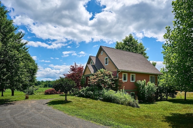 view of home's exterior with a lawn