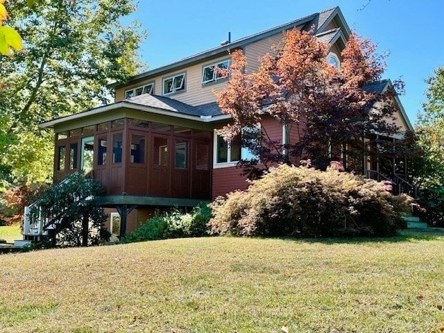 exterior space with a sunroom and a front lawn