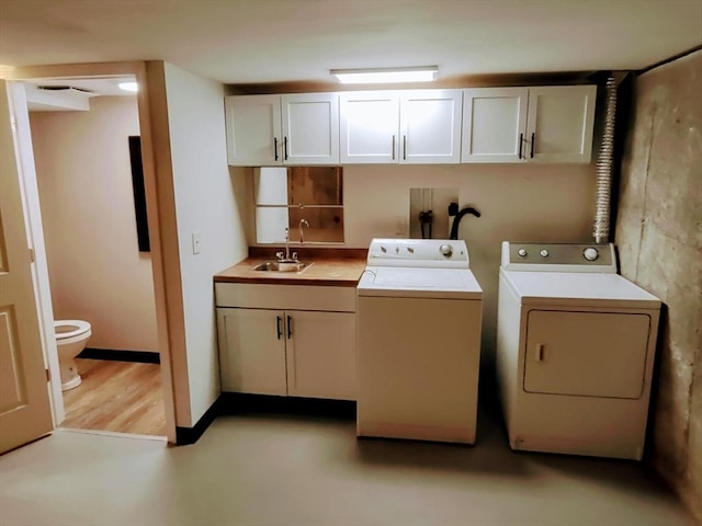 laundry area featuring washing machine and dryer and sink