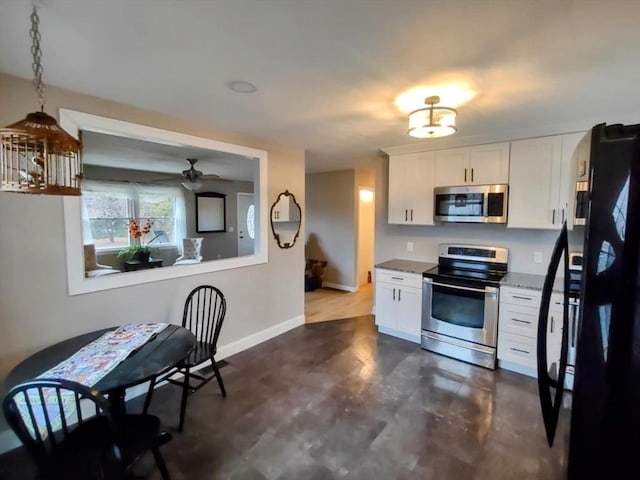 kitchen with white cabinets, appliances with stainless steel finishes, and ceiling fan