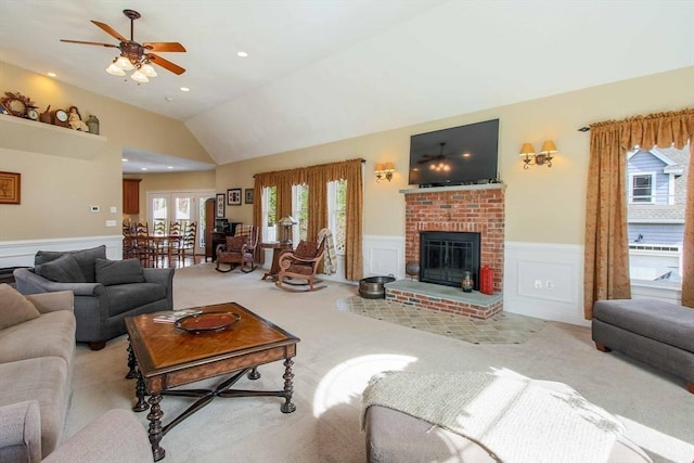 32 Erins Way, Holden, MA 01520 - living area with a wainscoted wall, light colored carpet, vaulted ceiling, ceiling fan, and a fireplace