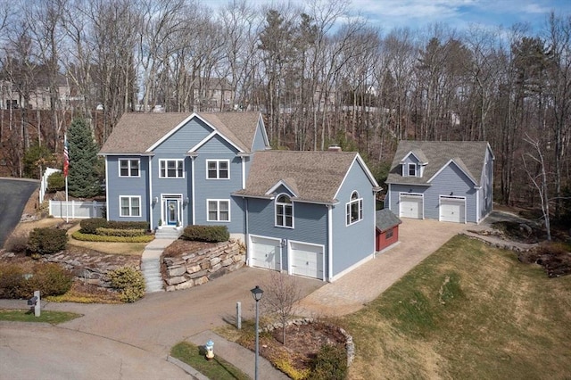 32 Erins Way, Holden, MA 01520 - traditional home with asphalt driveway, a garage, a front yard, view of scattered trees, and a shingled roof