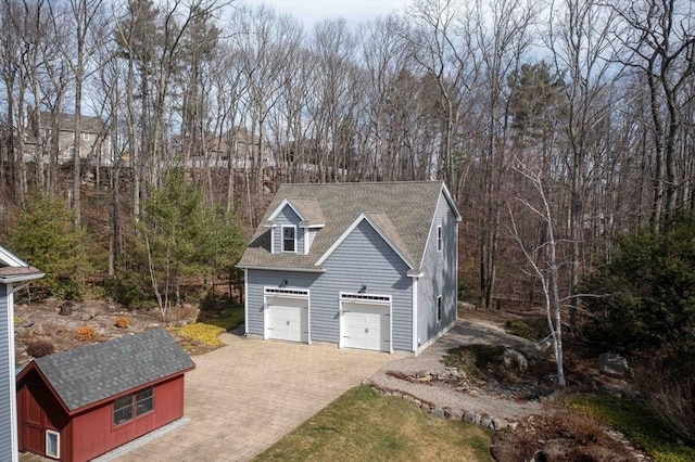 32 Erins Way, Holden, MA 01520 - garage with decorative driveway and view of scattered trees