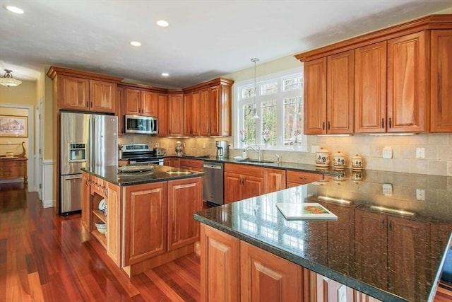32 Erins Way, Holden, MA 01520 - kitchen with appliances with stainless steel finishes, a sink, dark wood finished floors, a peninsula, and brown cabinets