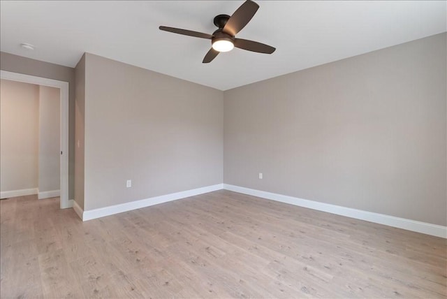 empty room featuring light wood-type flooring, ceiling fan, and baseboards