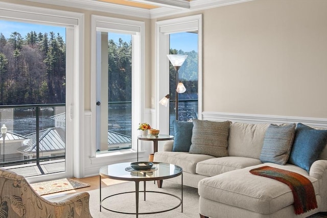 interior space featuring crown molding, wainscoting, and wood finished floors