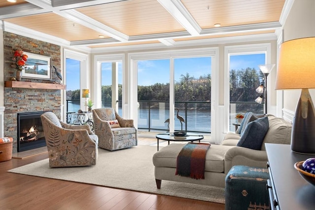 sunroom featuring a water view, coffered ceiling, and beamed ceiling