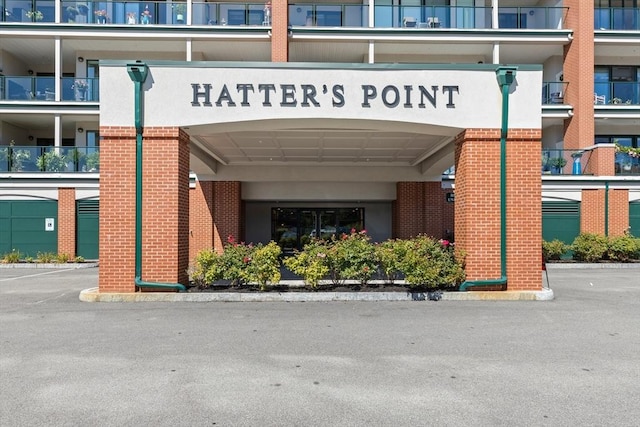 view of building exterior featuring uncovered parking