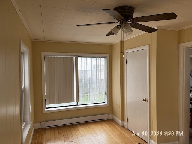 empty room with a baseboard radiator, light hardwood / wood-style flooring, ceiling fan, and ornamental molding