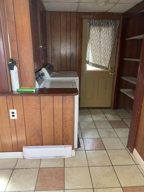 laundry room featuring washing machine and clothes dryer and wooden walls