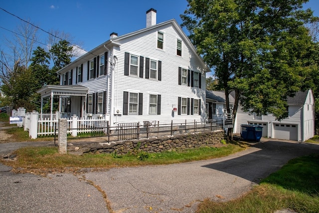 view of front of property featuring an outbuilding and a garage