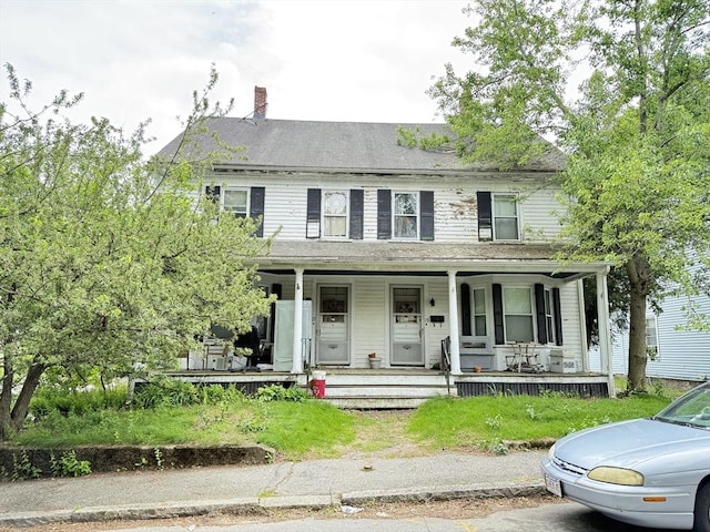 19 Davis St, Woburn, MA 01801 - view of front facade featuring a porch and a chimney