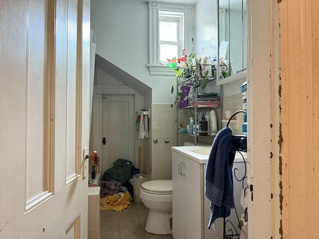 19 Davis St, Woburn, MA 01801 - bathroom featuring tile patterned flooring, tile walls, vanity, toilet, and a wainscoted wall