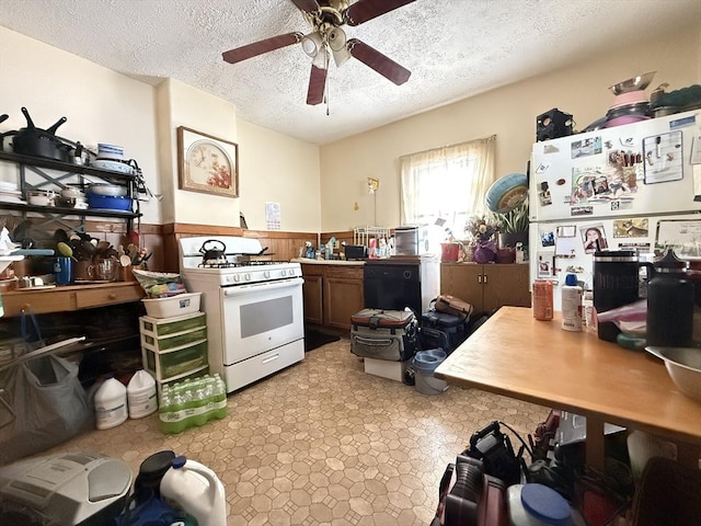 19 Davis St, Woburn, MA 01801 - kitchen with white appliances, wainscoting, ceiling fan, and a textured ceiling