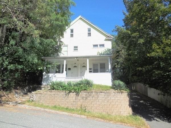 view of front of property with covered porch and fence