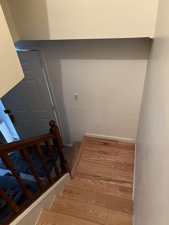 stairs featuring wood-type flooring