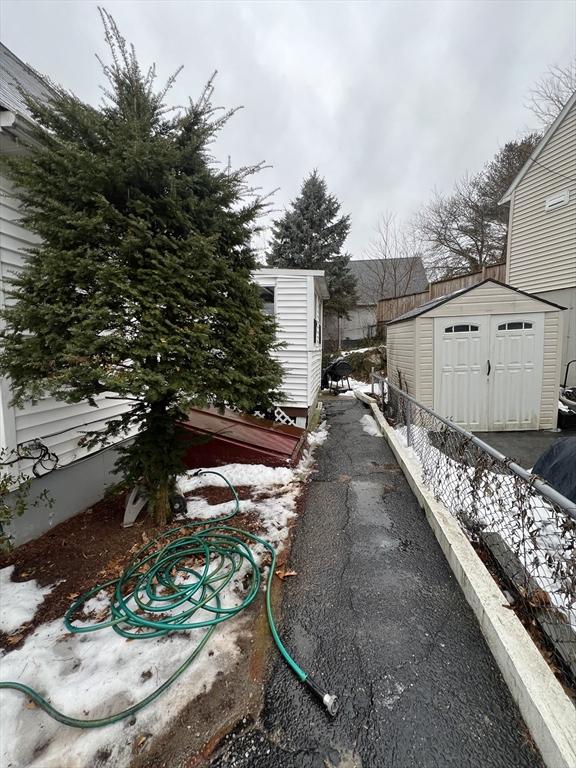 view of property exterior with a storage shed