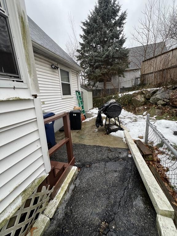 yard covered in snow featuring a patio