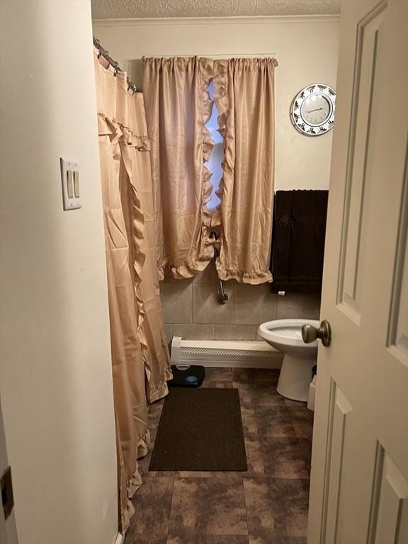 bathroom with a textured ceiling and toilet