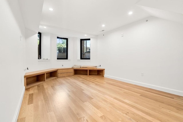 interior space with vaulted ceiling and light hardwood / wood-style flooring