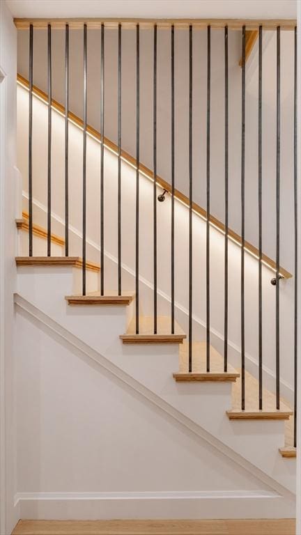 stairway with hardwood / wood-style floors