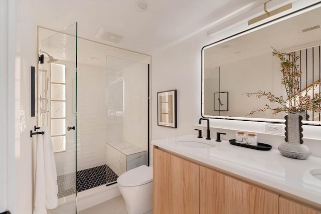 bathroom with vanity, toilet, and an enclosed shower