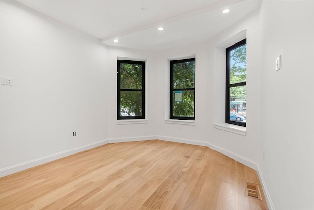 unfurnished room with light wood-type flooring