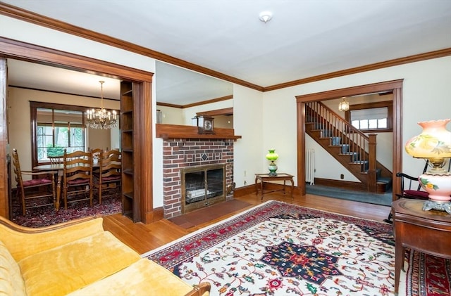 47 Ronald Rd, Arlington, MA 02474 - living area with wood finished floors, radiator heating unit, a chandelier, stairs, and ornamental molding