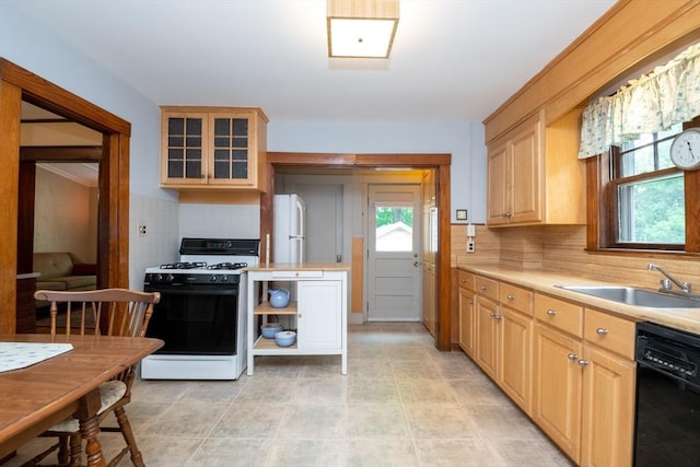 47 Ronald Rd, Arlington, MA 02474 - kitchen featuring range with gas cooktop, dishwasher, freestanding refrigerator, and light countertops