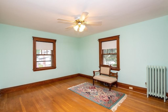 47 Ronald Rd, Arlington, MA 02474 - living area with radiator heating unit, baseboards, healthy amount of natural light, and wood finished floors