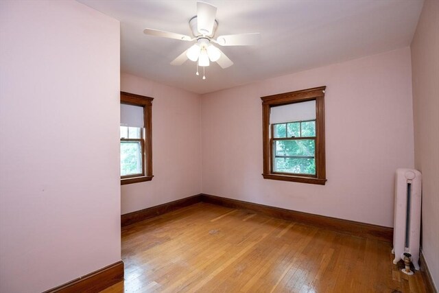 47 Ronald Rd, Arlington, MA 02474 - unfurnished room featuring radiator, baseboards, light wood-type flooring, and ceiling fan