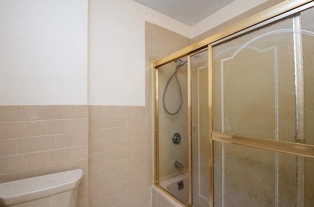 47 Ronald Rd, Arlington, MA 02474 - bathroom featuring tile walls, toilet, and enclosed tub / shower combo