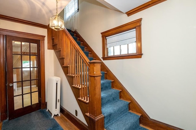 47 Ronald Rd, Arlington, MA 02474 - stairs featuring radiator, baseboards, wood finished floors, ornamental molding, and healthy amount of natural light