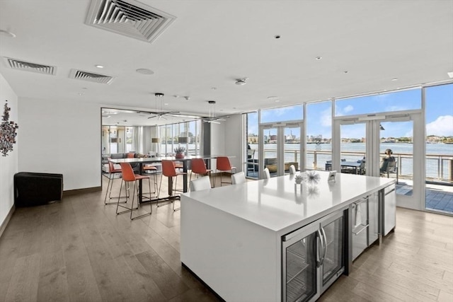 65 Lewis St Unit Ph03, Boston, MA 02128 - kitchen featuring visible vents, hardwood / wood-style flooring, and a large island