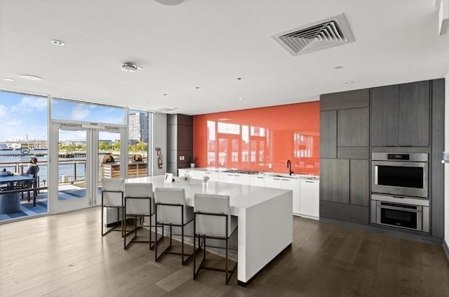 65 Lewis St Unit Ph03, Boston, MA 02128 - kitchen featuring modern cabinets, visible vents, light countertops, and dark wood finished floors